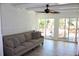 Bright living room with tile floors, modern ceiling fan and sliding glass doors at 5242 Potomac St, North Charleston, SC 29405