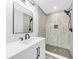 Updated bathroom with walk-in shower, modern vanity, and herringbone tile floor at 5889 N Rhett Ave, Hanahan, SC 29410