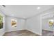 Bright bedroom with wood-look flooring and two windows at 5889 N Rhett Ave, Hanahan, SC 29410