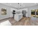 Modern kitchen with white cabinets, stainless steel appliances, and an island at 5889 N Rhett Ave, Hanahan, SC 29410