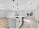 Modern kitchen with white cabinets, stainless steel appliances, and an island at 5889 N Rhett Ave, Hanahan, SC 29410