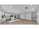 Open floor plan with hardwood floors, white cabinets, and an island at 5889 N Rhett Ave, Hanahan, SC 29410