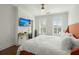 Bright bedroom with large bed, TV, and plantation shutters at 712 S Shelmore Blvd # 15, Mount Pleasant, SC 29464