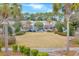Green grassy park with palm trees and shops in background at 712 S Shelmore Blvd # 15, Mount Pleasant, SC 29464