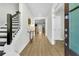 Bright and spacious entryway with hardwood floors, staircase, and a console table at 7759 Park Gate Dr, North Charleston, SC 29418