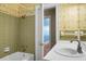 Green tiled bathroom with tub and vanity at 917 S Main St, Summerville, SC 29483