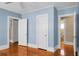 Bedroom with light blue walls, wood floors, and closets at 917 S Main St, Summerville, SC 29483