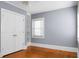 Bedroom with hardwood floors, double-door closet, built-in shelves, and window at 917 S Main St, Summerville, SC 29483
