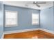 Blue bedroom with wood floors and ceiling fan at 917 S Main St, Summerville, SC 29483