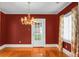 Dining room with hardwood floors, chandelier, and red walls at 917 S Main St, Summerville, SC 29483