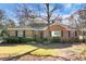 Brick home with black front door and mature trees at 917 S Main St, Summerville, SC 29483