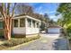Side view of home with sunroom and detached garage at 917 S Main St, Summerville, SC 29483