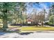Front view of charming brick home with mature trees at 917 S Main St, Summerville, SC 29483