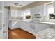 Bright kitchen featuring white cabinets and wood floors at 917 S Main St, Summerville, SC 29483