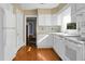 Kitchen with white cabinets, wood floors, and view to another room at 917 S Main St, Summerville, SC 29483