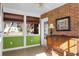 Sunroom with brick walls, wood floors, and a ceiling fan at 917 S Main St, Summerville, SC 29483