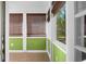 Sunroom with green walls, tile floors, and bamboo shades at 917 S Main St, Summerville, SC 29483