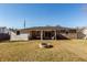 Spacious backyard featuring a covered patio and fire pit at 9772 Berrywood Dr, Ladson, SC 29456