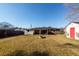 Large backyard with covered patio, fire pit, and storage shed at 9772 Berrywood Dr, Ladson, SC 29456