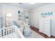 Baby's room with white dresser and crib, and nautical theme decor at 9772 Berrywood Dr, Ladson, SC 29456