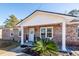 Brick ranch house with a light blue front door and landscaping at 9772 Berrywood Dr, Ladson, SC 29456