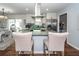 Updated kitchen with white cabinets, granite island, and stainless steel appliances at 9772 Berrywood Dr, Ladson, SC 29456