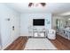 Living room with hardwood floors, white walls, and a cozy sitting area at 9772 Berrywood Dr, Ladson, SC 29456