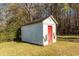 White shed with red door in a sunny backyard at 9772 Berrywood Dr, Ladson, SC 29456