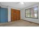 Bedroom with wood closet doors and window at 1088 Quiet Rd, Mount Pleasant, SC 29464