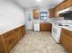 Efficient kitchen with wood cabinets, white appliances, and tile floor at 1104 Berkeley St, Hanahan, SC 29410