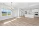 Bright dining area with hardwood floors, chandelier and view to backyard at 115 Crosscut Ln, Summerville, SC 29486