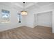 Elegant dining room featuring hardwood floors, chandelier, and built-in shelving at 115 Crosscut Ln, Summerville, SC 29486