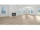 Spacious living room with hardwood floors, fireplace, and large windows at 115 Crosscut Ln, Summerville, SC 29486