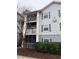 Three-story building featuring gray siding, screened porches, and classic shutters at 1300 Park West Blvd # 110, Mount Pleasant, SC 29466