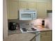 Modern kitchen with white appliances and wood cabinets at 1300 Park West Blvd # 110, Mount Pleasant, SC 29466