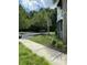 View of the parking lot with palm trees and green landscaping near the building at 1300 Park West Blvd # 110, Mount Pleasant, SC 29466