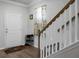 Entryway with white door, shoe rack, and stairs with wooden railing at 149 Cypress Preserve Blvd, Moncks Corner, SC 29461