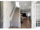 Bright entryway with stairs, wooden railing and a view into the living room at 149 Cypress Preserve Blvd, Moncks Corner, SC 29461