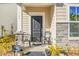 Front porch with two black chairs and stone accents at 149 Cypress Preserve Blvd, Moncks Corner, SC 29461