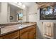 Bathroom with granite countertop, wood cabinets, and a mirror at 149 High Hammock Villas, Seabrook Island, SC 29455