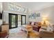 Spacious living room featuring a large window and sliding doors to a balcony at 149 High Hammock Villas, Seabrook Island, SC 29455