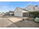 White garage with dark brown fence, spacious driveway, and landscaping at 212 Magnolia Garden Dr, Summerville, SC 29483