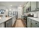 Modern kitchen with stainless steel appliances and light green cabinets at 212 Magnolia Garden Dr, Summerville, SC 29483