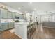 Modern kitchen with light green cabinets and white island at 212 Magnolia Garden Dr, Summerville, SC 29483