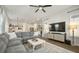 Open living room with sectional sofa, large TV, and view into kitchen at 212 Magnolia Garden Dr, Summerville, SC 29483