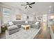 Bright living room featuring a large sectional sofa, coffee table, and hardwood floors at 212 Magnolia Garden Dr, Summerville, SC 29483