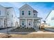 Two-story house with light blue siding, front porch, and driveway at 225 Witherspoon St, Summerville, SC 29486