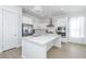 Open concept kitchen with white cabinets, island, and stainless steel appliances at 225 Witherspoon St, Summerville, SC 29486