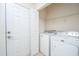 Convenient laundry room with washer, dryer, and built-in shelving at 234 Sea Lavender Ln, Summerville, SC 29486