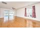 Bright living room featuring hardwood floors, a view of the water, and red floral curtains at 234 Sea Lavender Ln, Summerville, SC 29486